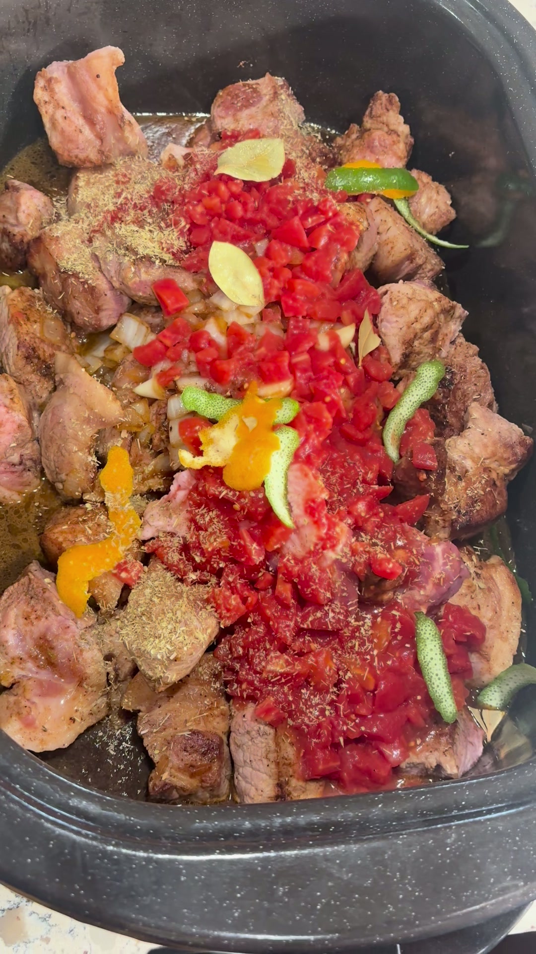 Dried oregano flecks sprinkled across the tomatoes and meat